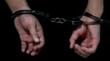 A person in handcuffs at Moscow's Basmanny District Court